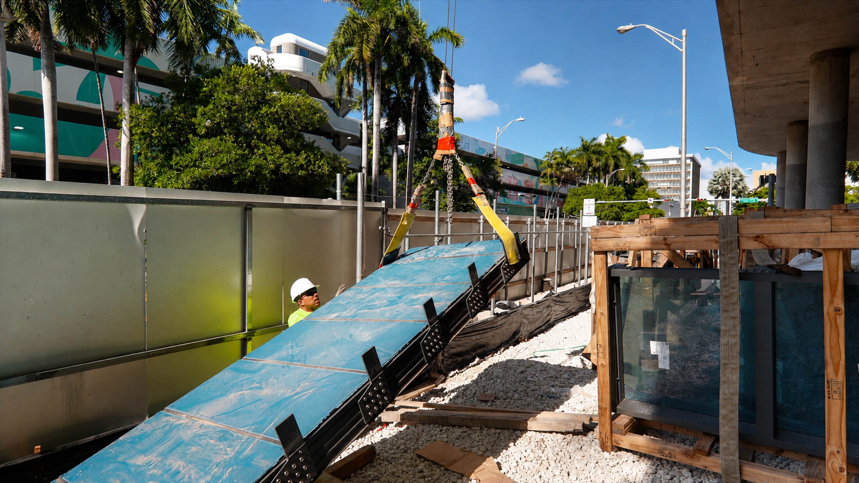 Large custom glass panel being positioned for installation