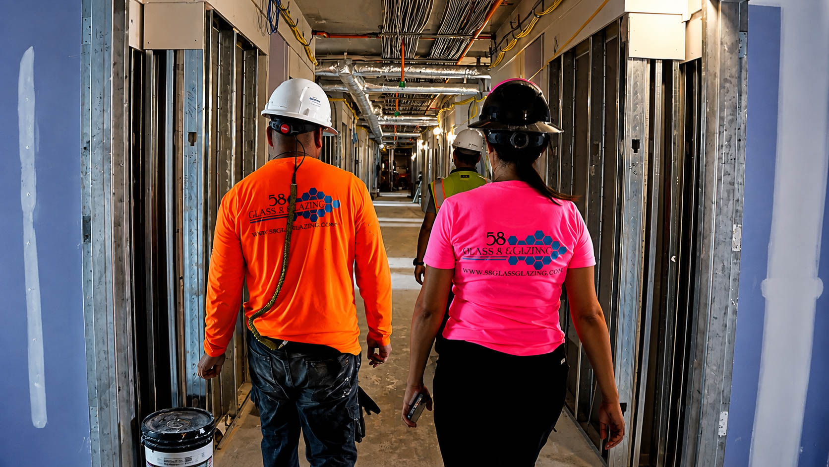 58 Glass & Glazing team walking through an active construction site